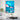 Large blue moon glass wall art hanging in a spacious and modern living room as home decor.