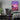 A gaming room, featuring a cool pink canvas print hanging as wall decor.