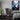 A gaming room featuring the Satoru Gojo wall art next to a gaming computer setup.