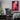 Naruto modern acrylic wall art hanging in a gaming room next to a computer set up, showing its bright colors.
