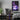 Purple city (Chicago-inspired) canvas hanging besides a gaming setup as room decor.