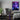 A gaming room, featuring the bright anime wall art hanging above the gaming setup, as room decor.
