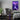 A gaming bedroom featuring the purple raven acrylic wall art as room decor.